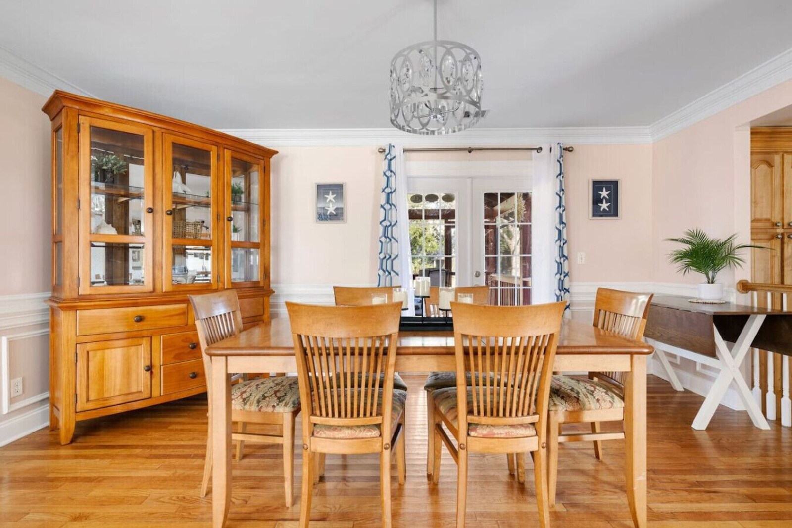 Dining room with seating for six and doors to the porch